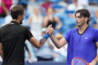 Daniil Medvedev, left, of Russia, shakes hands with Taylor Fritz, of the United States, after their quarterfinal match at the Western & Southern Open tennis tournament Friday, Aug. 19, 2022, in Mason, Ohio. Medvedev won 7-6 (1), 6-3. (AP Photo/Jeff Dean)