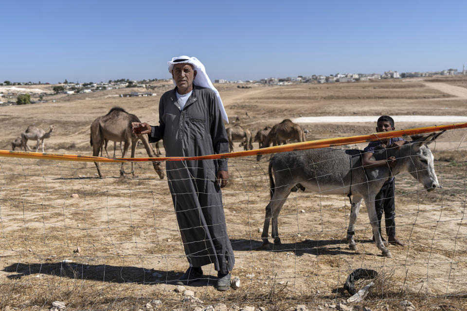 A man stands at the edge of a 1,200-year-old rural estate discovered during excavations by the Israel Antiquities Authority during expansion of the town of Rahat, Israel, Tuesday, Aug. 23, 2022. Located in Israel's south near the Bedouin town of Rahat, the building dates back back to the early Islamic period in the 8th or 9th centuries. (AP Photo/Tsafrir Abayov)