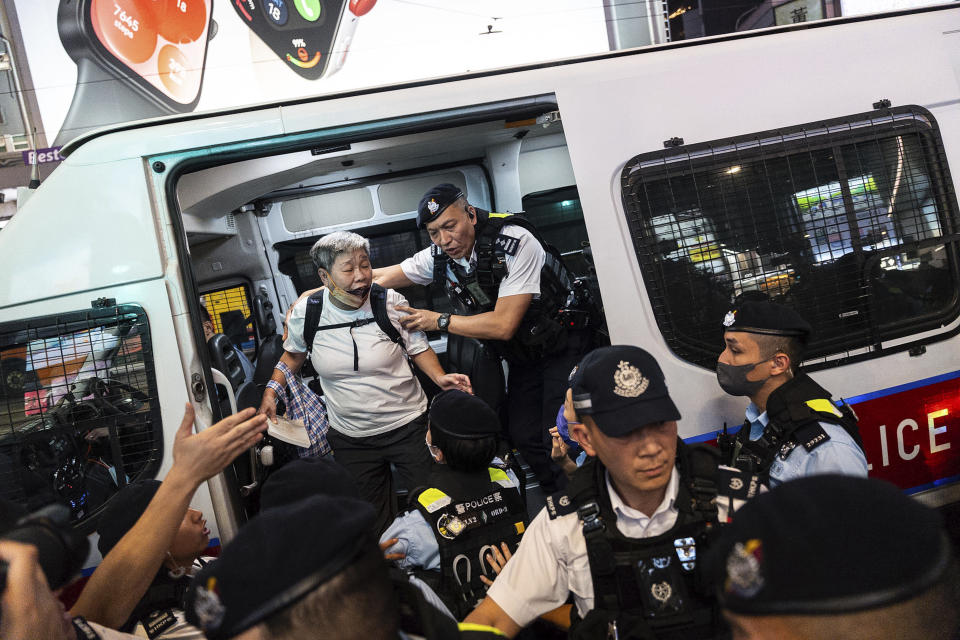 Police officers detained a resident in Causeway Bay area on the 35th anniversary of China's Tiananmen Square crackdown, in Hong Kong, Tuesday, June 4, 2024. (AP Photo/Chan Long Hei)