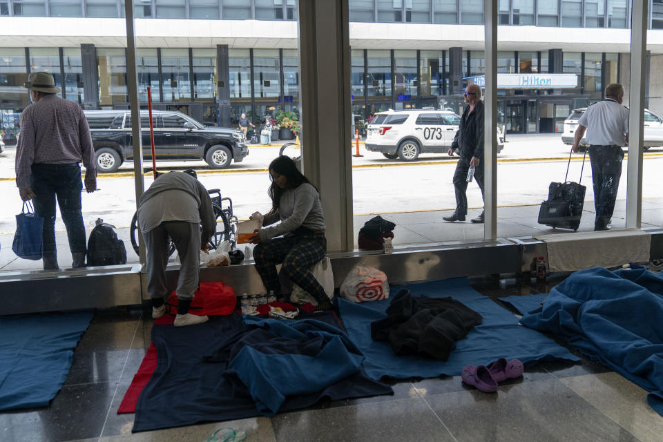 Run by a private firm hired by the city, migrants stay in a makeshift shelter at O'Hare International Airport, Wednesday, Sept. 20, 2023, in Chicago. Unlike migrants in the public eye at police stations, the migrants at O'Hare and a handful at Midway International Airport have limited access to resources, including showers and medical care. (AP Photo/Erin Hooley)