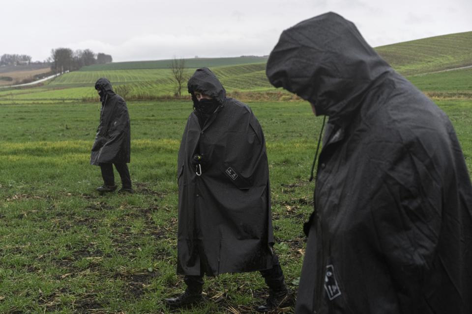 Polish police officers search for missile wreckage in the field, near the place where a missile struck, killing two people in a farmland at the Polish village of Przewodow, near the border with Ukraine, Wednesday, Nov. 16, 2022. (AP Photo/Evgeniy Maloletka)