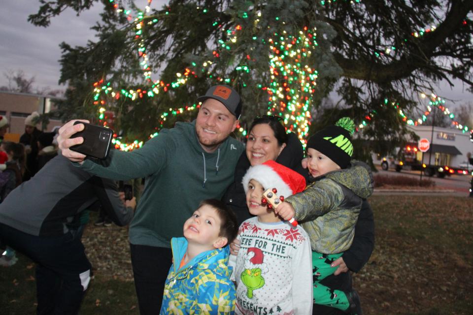 Chris, Becca, Corbin (5), Carter (7) and Calvin (2) Cooling take a photo in front of the lit tree on the northeast corner of the downtown square during the Hometown Holiday Celebration on Friday, Dec. 2, 2022, in Adel.