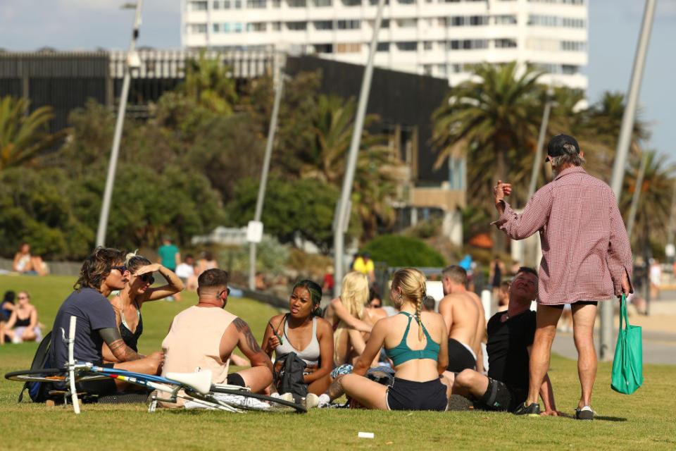 People are seen at St Kilda Beach in Melbourne, Australia.