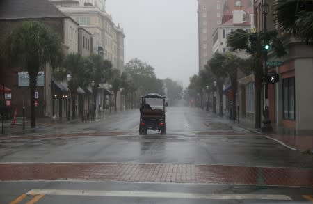 A golf cart travels down King Street during Hurricane Dorian in Charleston