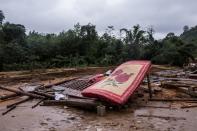 The house of villager Ho Van Suot is seen after it was destroyed by a landslide in Quang Tri province