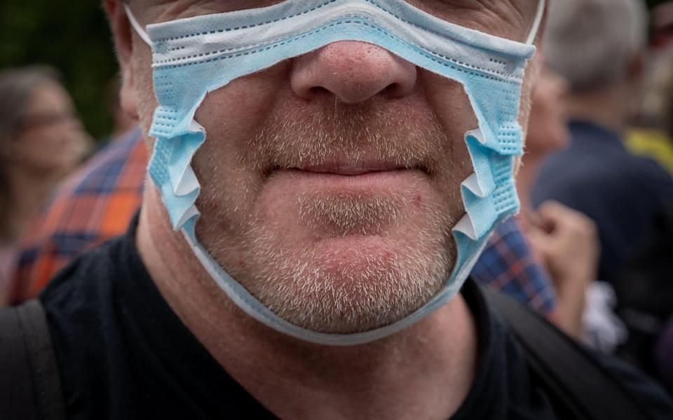 A crowd member at the 'Keep Britain Free' demo in Hyde Park-  a protest arranged in response to the Government’s decision to impose mask wearing for shoppers on 24th July. Organisers and protesters say imposing masks breaches personal liberty