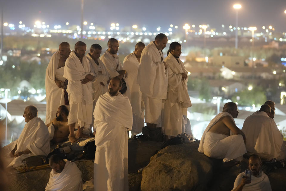 Muslim pilgrims gather at top of the rocky hill known as the Mountain of Mercy, on the Plain of Arafat, during the annual Hajj pilgrimage, near the holy city of Mecca, Saudi Arabia, Saturday, June 15, 2024. Masses of Muslims gathered at the sacred hill of Mount Arafat in Saudi Arabia for worship and reflection on the second day of the Hajj pilgrimage. The ritual at Mount Arafat, known as the hill of mercy, is considered the peak of the Hajj. It's often the most memorable event for pilgrims, who stand shoulder to shoulder, asking God for mercy, blessings, prosperity and good health. Hajj is one of the largest religious gatherings on earth.(AP Photo/Rafiq Maqbool)