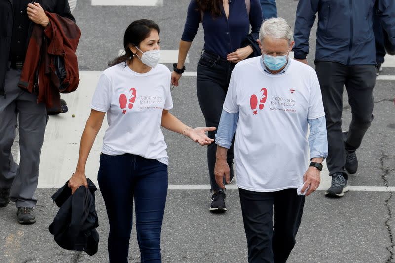 Vina Nadjibulla, wife of Michael Kovrig, speaks to Minister of Foreign Affairs Marc Garneau during a march in support of Michael Kovrig and Michael Spavor in Ottawa