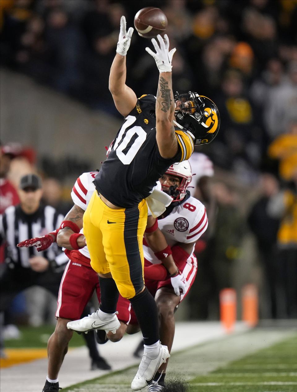 Iowa wide receiver Arland Bruce IV reaches for the ball in the fourth quarter against Nebraska on Nov. 25.