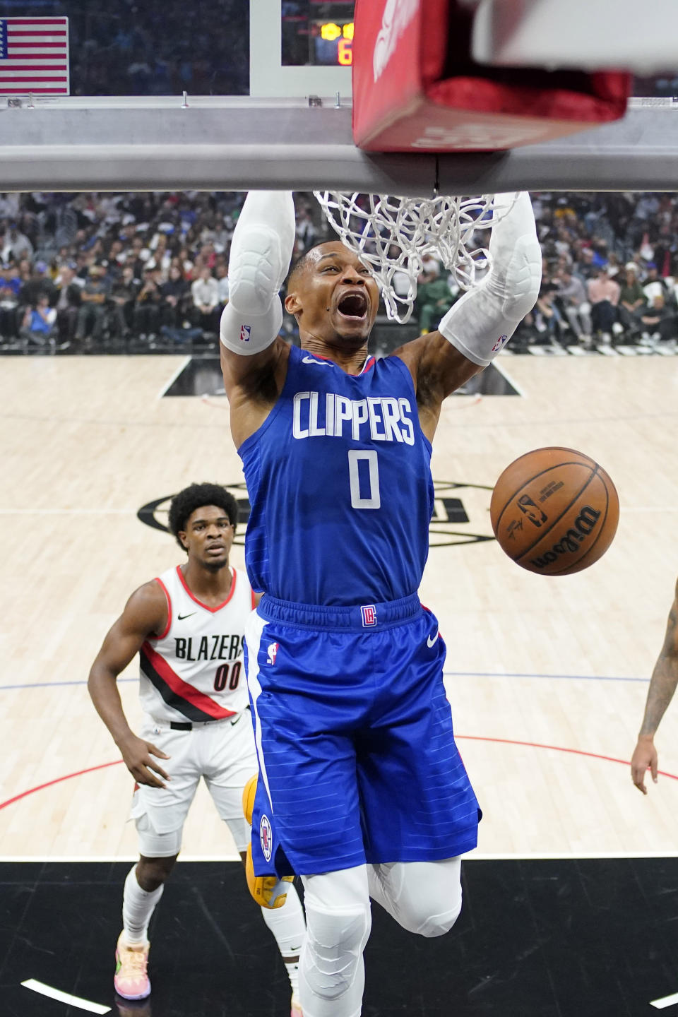 Los Angeles Clippers guard Russell Westbrook, right, dunks as Portland Trail Blazers guard Scoot Henderson watches during the first half of an NBA basketball game Wednesday, Oct. 25, 2023, in Los Angeles. (AP Photo/Mark J. Terrill)