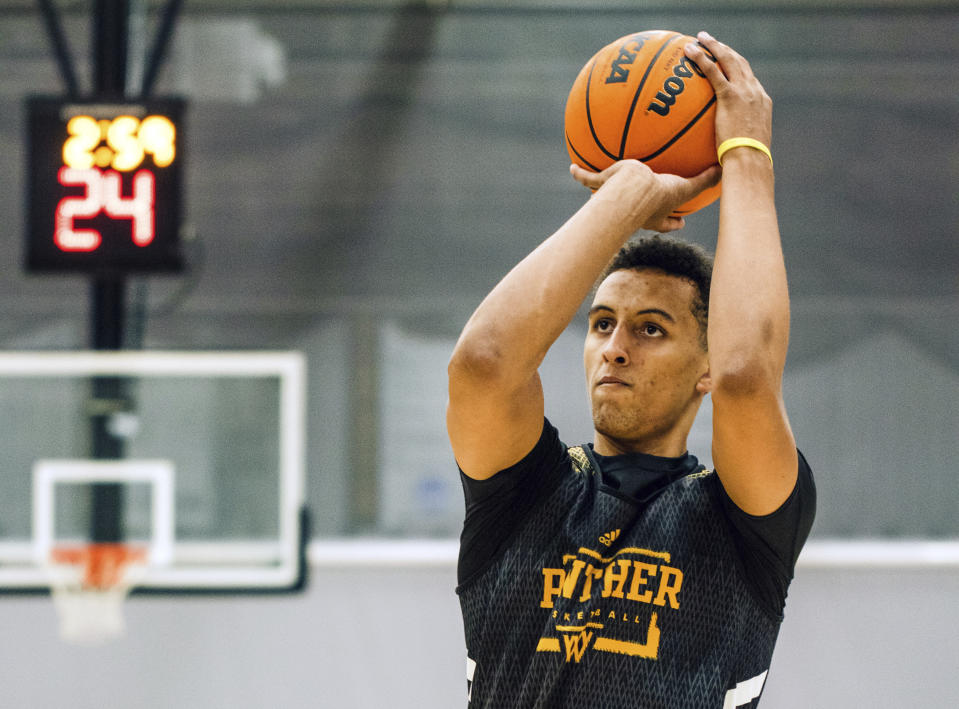 In this image provided by Milwaukee Athletics, Milwaukee freshman Patrick Baldwin works out during the Panthers’ first day of preseason NCAA college basketball practice, Tuesday, Sept. 28, 2021, in Milwaukee. Baldwin, rated as one of the nation’s top 10 prospects in his class, passed up offers from blueblood programs to play college basketball on a Milwaukee team that is coached by his father. (Ashley Steltenpohl/Milwaukee Athletics via AP)