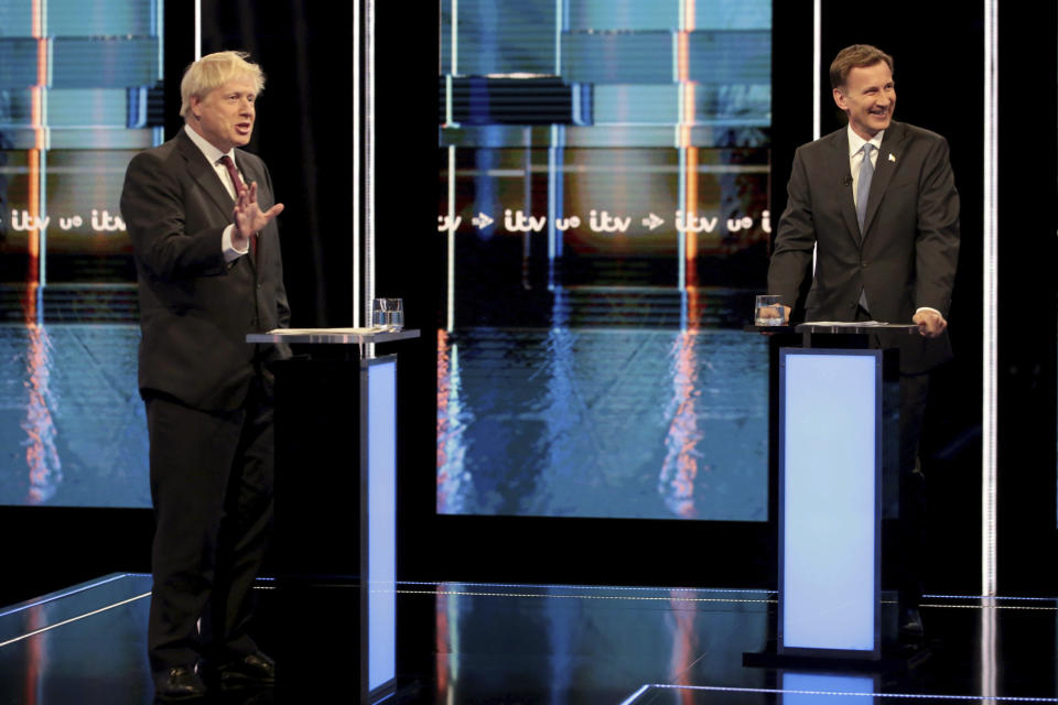 In this photo issued by ITV, showing Britain's Conservative Party leadership candidates Boris Johnson, left, and Jeremy Hunt, during a live head-to-head TV debate hosted by ITV at their studios in Salford, England, Tuesday July 9, 2019. The two contenders, Jeremy Hunt and Boris Johnson are competing for votes from party members, with the winner replacing Prime Minister Theresa May as party leader and Prime Minister of Britain's ruling Conservative Party. (Matt Frost/ITV via AP)