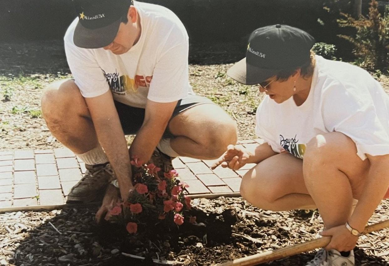 Two volunteers plant flowers during a United Way of the Ozarks' Day of Caring.