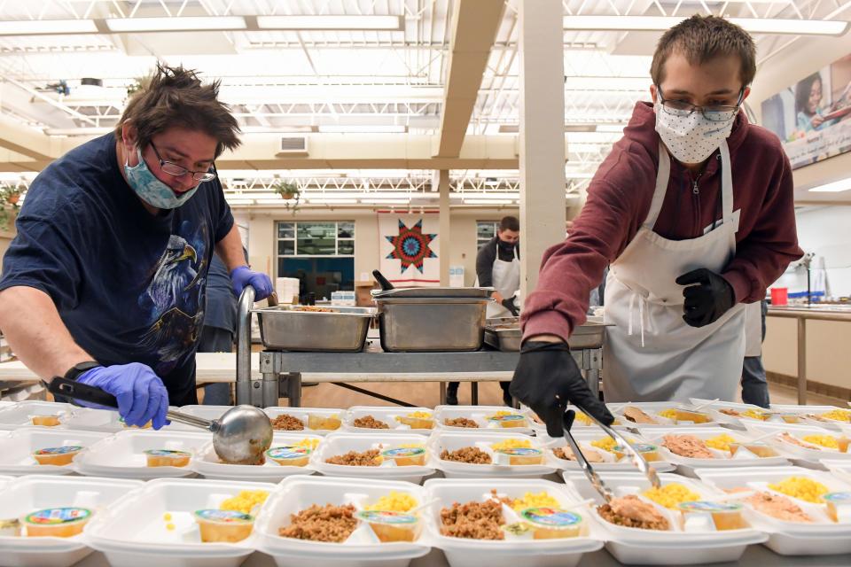 Volunteers package to-go meals on Wednesday, November 18, at The Banquet in Sioux Falls.