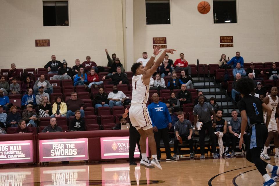 Walsh's Kobe Mitchell shoots a deep 3 during this year's regular season opener against Grand Valley State.