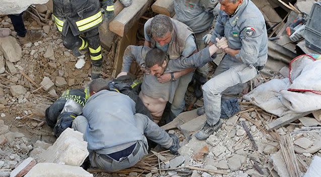 A man is rescued from the ruins following an earthquake in Amatrice. Photo: Reuters/Remo Casilli