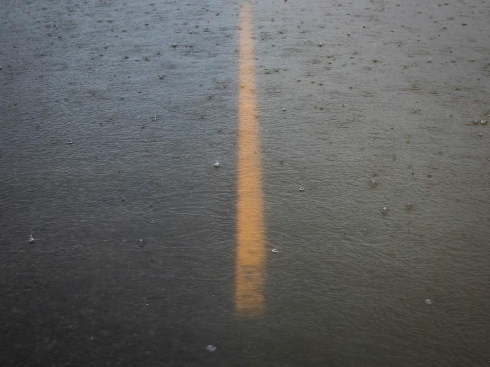 A road is pictured underwater in the Sumas Prairie flood zone in Abbotsford, B.C., on Tuesday. The city had its wettest November ever, with 541 millimetres of rain. (Ben Nelms/CBC - image credit)