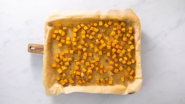 Roasted pumpkin cubes on tray 