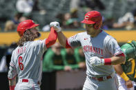Cincinnati Reds' Luke Maile, right, is congratulated by Jace Peterson after hitting a solo home run against the Oakland Athletics during the third inning of a baseball game in Oakland, Calif., Saturday, April 29, 2023. (AP Photo/John Hefti)