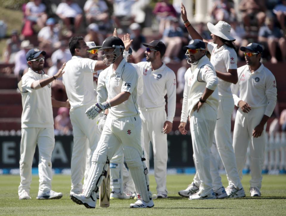 New Zealand's Hamish Rutherford walks off as India celebrates during the second innings on day three of the second international test cricket match at the Basin Reserve in Wellington February 16, 2014.