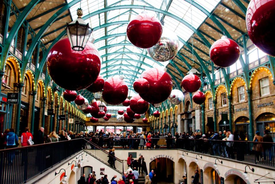 Covent Garden hosts a Christmas market each year, often decorated by giant baubles or gigantic bells with bows (Getty Images/iStockphoto)