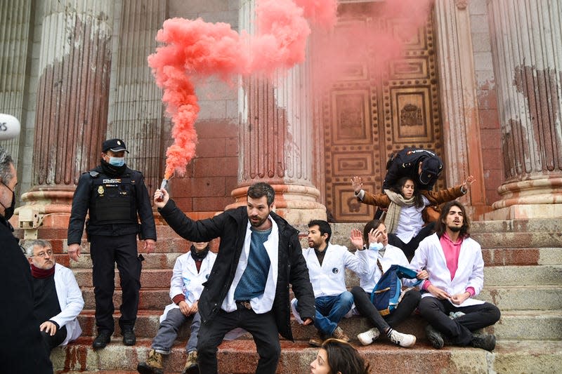 Climate activists in Madrid protested on blood stained steps during a week of global disobedience in April 2022. 