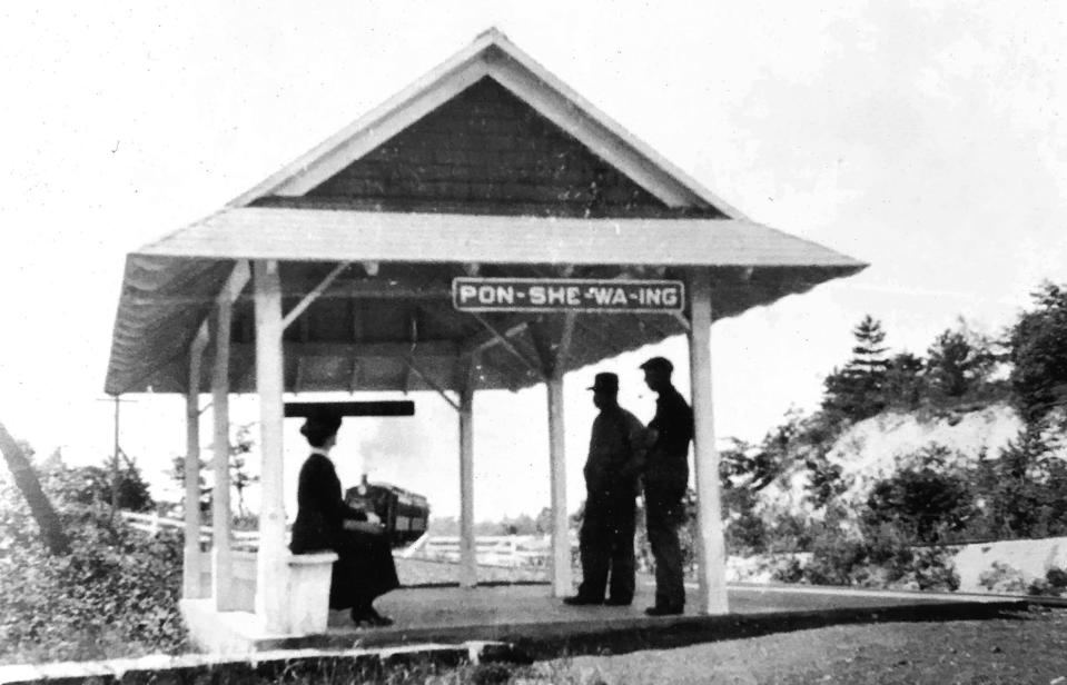 With the train approaching in the background, passengers awaiting pick-up at the Ponshewaing flag stop bide their time.