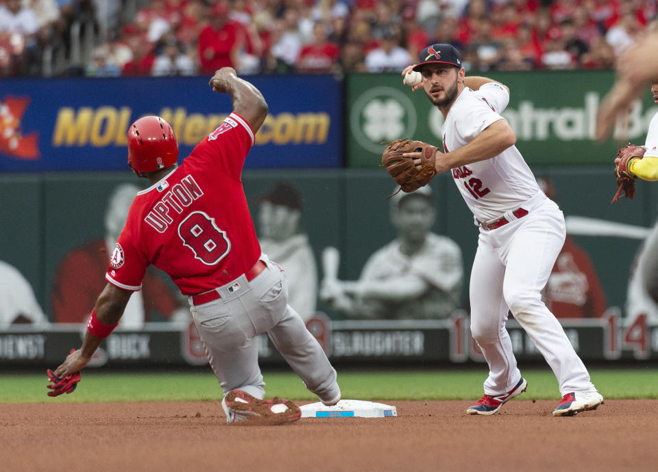 St. Louis Cardinals shortstop Paul DeJong, right, turns a double play over Los Angeles Angels' Justin Upton, left, during the third inning of a baseball game Sunday, June 23, 2019, in St. Louis. Kole Calhoun was out at first. (AP Photo/L.G. Patterson)
