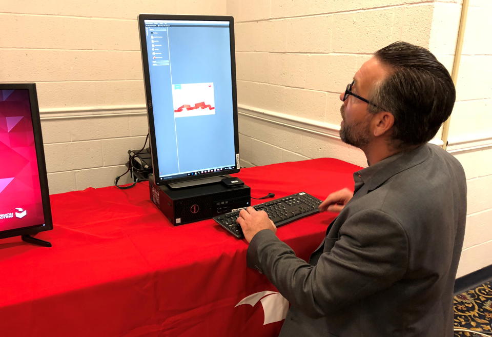 Eric Coomer demonstrates one of the company's voting machines, in Harrisburg, Pennsylvania, U.S., April 26, 2018. Picture taken April 26, 2018.  REUTERS/Sharon Bernstein 