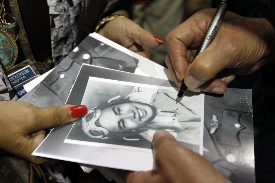 Tuskegee Airmen George Biggs signs an autograph in 2012 at the Commemorative Air Force Arizona Wing Aviation Museum in Mesa.