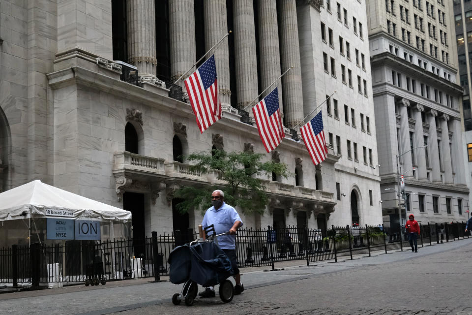 NEW YORK, NEW YORK - OCTOBER 02: People walk by the New York Stock Exchange (NYSE) in lower Manhattan on October 02, 2020 in New York City. Stocks and markets around the world have fallen in morning trading as investors digest the overnight news that President Donald Trump has Covid-19. (Photo by Spencer Platt/Getty Images)