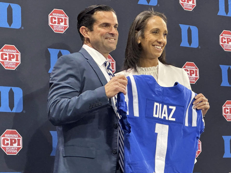 New Duke head football coach Manny Diaz holds a jersey with Duke Athletic Director Nina King, Saturday, Dec. 9, 2023 in Durham, N.C. Duke announced Diaz's hiring on Thursday night, capping a 10-day search after Elko boarded an overnight flight to A&M. (AP Photo/Aaron Beard)