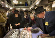 <p>Lithuanian Jews light candles during a commemoration ceremony on International Holocaust Remembrance Day, in the Synagogue in Vilnius, Lithuania, Thursday, Jan. 26, 2017. (Photo: Mindaugas Kulbis/AP) </p>