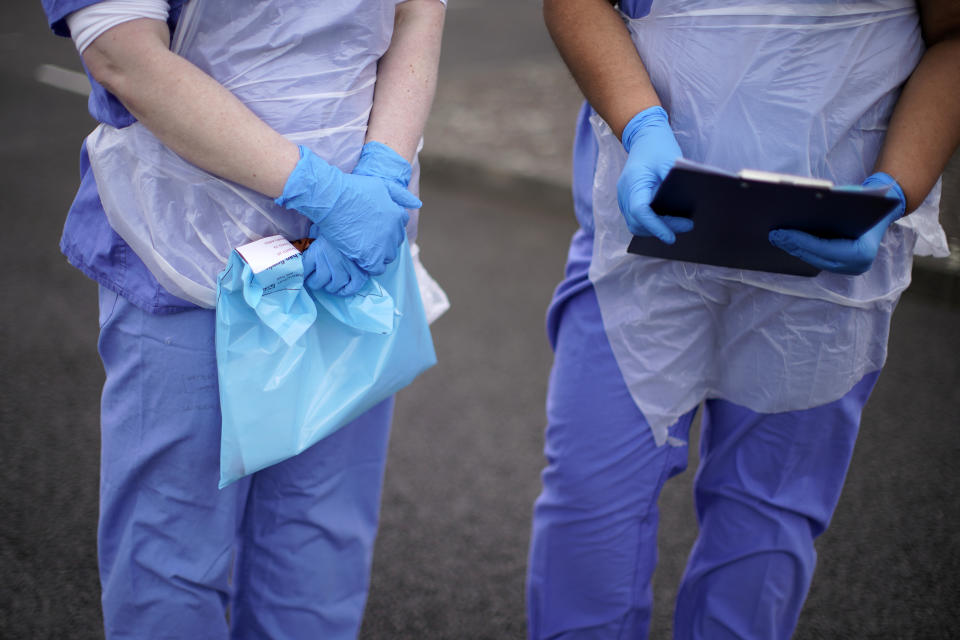 WOLVERHAMPTON, ENGLAND - MARCH 12: A NHS nurse holds a Coronavirus testing kit as she speaks to the media at a drive through Coronavirus testing site in a car park on March 12, 2020 in Wolverhampton, England. The National Health Service facility has been set up in a car park to allow people with NHS referrals to be swabbed for Covid-19. (Photo by Christopher Furlong/Getty Images)