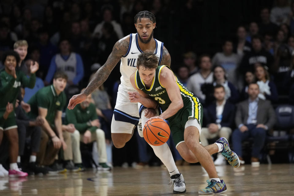 Le Moyne's Mike DePersia, right, tries to get past Villanova's Justin Moore during the first half of an NCAA college basketball game, Friday, Nov. 10, 2023, in Villanova, Pa. (AP Photo/Matt Slocum)