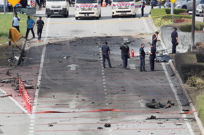 Authorities inspect the scene of a plane crash in Shah Alam