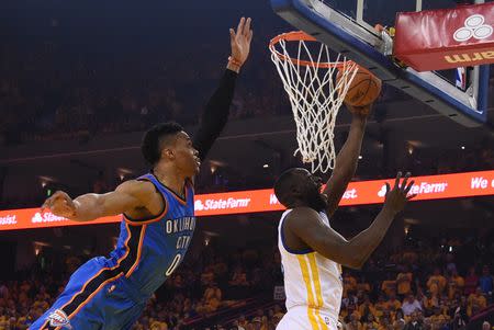 May 30, 2016; Oakland, CA, USA; Golden State Warriors forward Draymond Green (23) shoots the basketball against Oklahoma City Thunder guard Russell Westbrook (0) during the first quarter in game seven of the Western conference finals of the NBA Playoffs at Oracle Arena. Mandatory Credit: Kyle Terada-USA TODAY Sports / Reuters Picture Supplied by Action Images