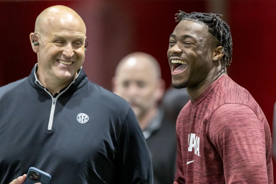 Alabama quarterback Jalen Milroe, right, laughs as he talks with the SEC Network's Cole Cubelic at Alabama's NFL football pro day, Wednesday, March 20, 2024, in Tuscaloosa, Ala. (AP Photo/Vasha Hunt)
