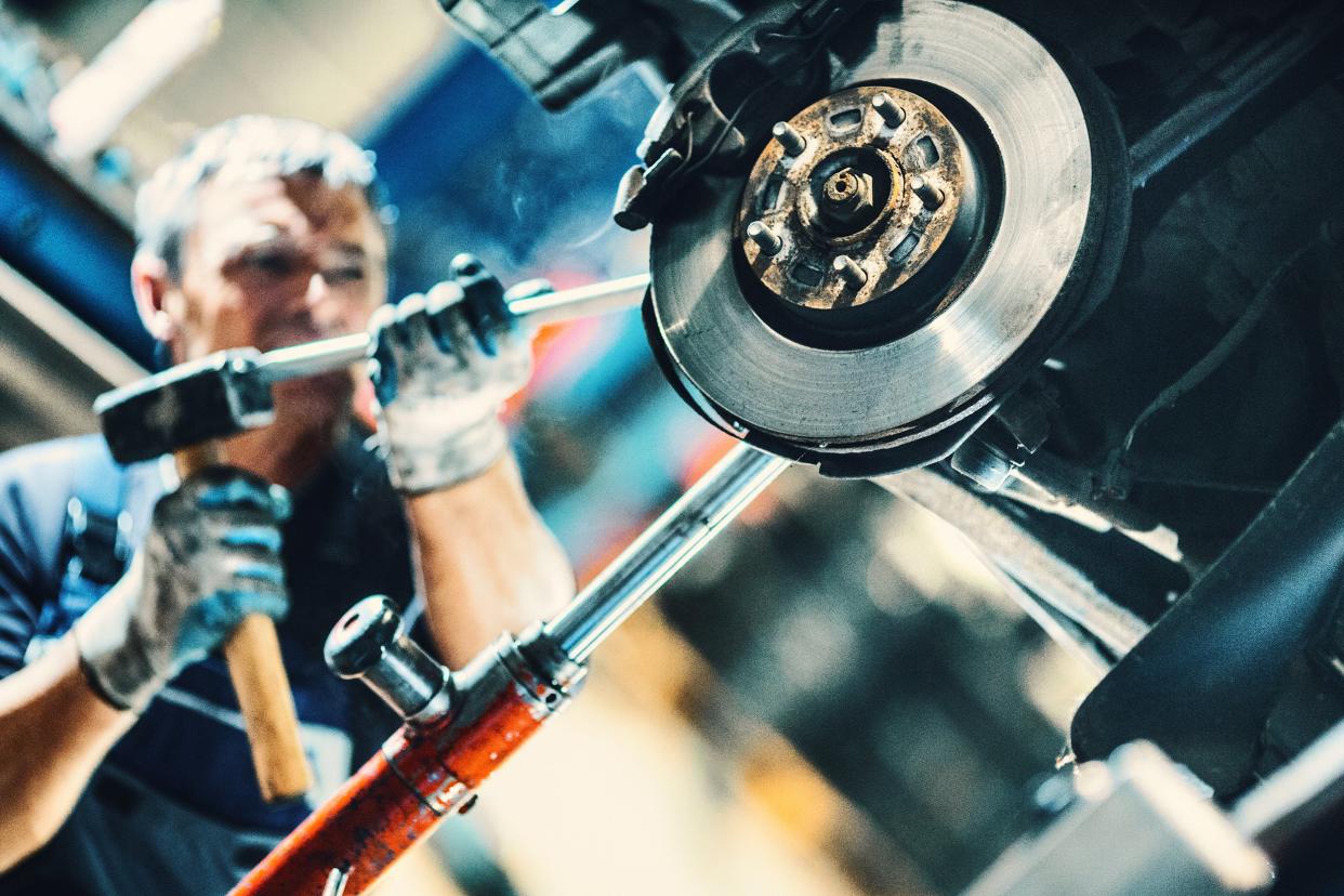 mechanic at work on the breaks