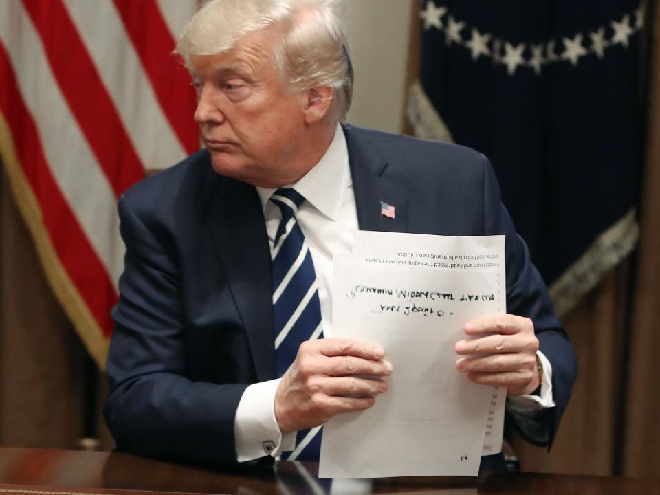 U.S. President Donald Trump holds his notes as he talks about his meeting with Russian President Vladimir Putin, during a meeting with House Republicans in the Cabinet Room of the White House on July 17, 2018 in Washington, DC.