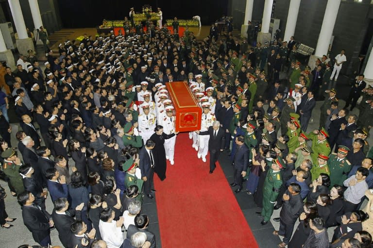 Quang's wife wept as his red coffin, emblazoned with Vietnam's national logo, was lowered into the ground by about 20 soldiers in crisp white uniforms