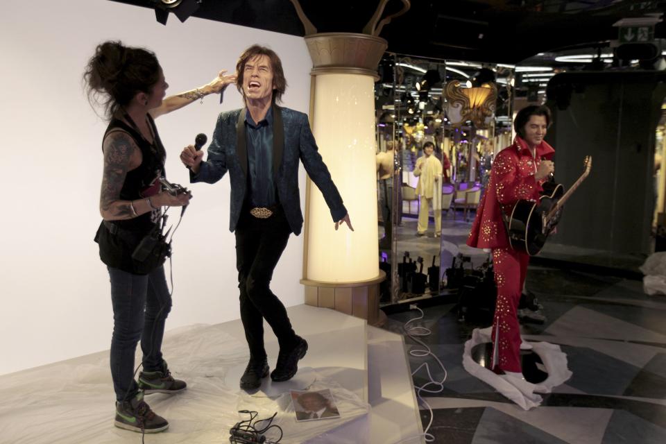 Paris' Grevin Wax Museum hairdresser Virginie Dahan puts the final touches to Rolling Stones lead singer Mick Jagger's statue at the Grevin Wax Museum in Prague