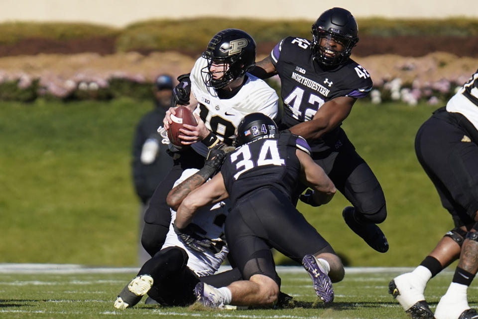 Purdue quarterback Bennett Meredith, left, gets sacked by Northwestern defensive lineman Anto Saka during the first half of an NCAA college football game, Saturday, Nov. 18, 2023, in Evanston, Ill. (AP Photo/Erin Hooley)