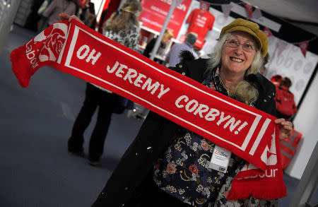 An attendee poses with her scarf ahead of Britain's opposition Labour Party leader Jeremy Corbyn delivering his keynote speech at the Labour Party Conference in Brighton, Britain, September 27, 2017. REUTERS/Toby Melville