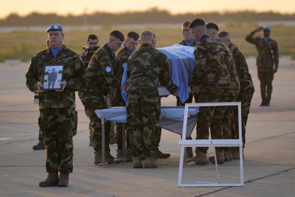 Irish U.N peacekeepers, carry the coffin draped by the United Nations flag of their comrade Pvt. Seán Rooney of Newtowncunningham who was killed during a confrontation with residents near the southern town of Al-Aqbiya on Wednesday night, during his memorial procession at the Lebanese army airbase, at Beirut airport, Sunday, Dec. 18, 2022. (AP Photo/Hussein Malla)