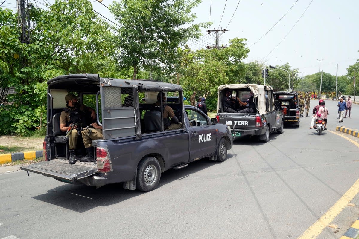 Police officers patrolling around the residence of Imran Khan on 18 May (AP)