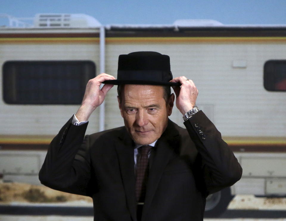 Cast member Bryan Cranston, from the award-winning television series "Breaking Bad", tries on his character Walter White's Heisenberg Hat one last time during a donation of the show's memorabilia at the Smithsonian Museum of American History in Washington November 10, 2015. REUTERS/Gary Cameron          TPX IMAGES OF THE DAY     