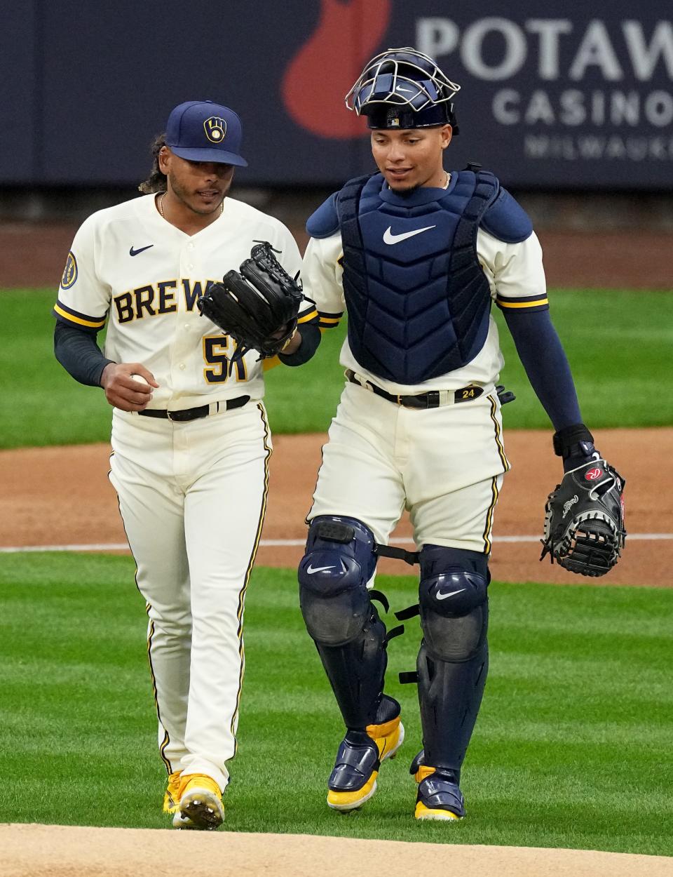 Milwaukee Brewers starting pitcher Freddy Peralta (51) and catcher William Contreras (24) talk during the first inning of their game against the New York Mets Monday, April 3, 2023 at American Family Field in Milwaukee, Wis.