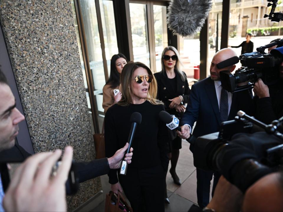 Giggle for Girls founder Sall Grover (centre) speaks to the media as she leaves the Federal Court of Australia in Sydney, Australia, 23 August 2024 (EPA)