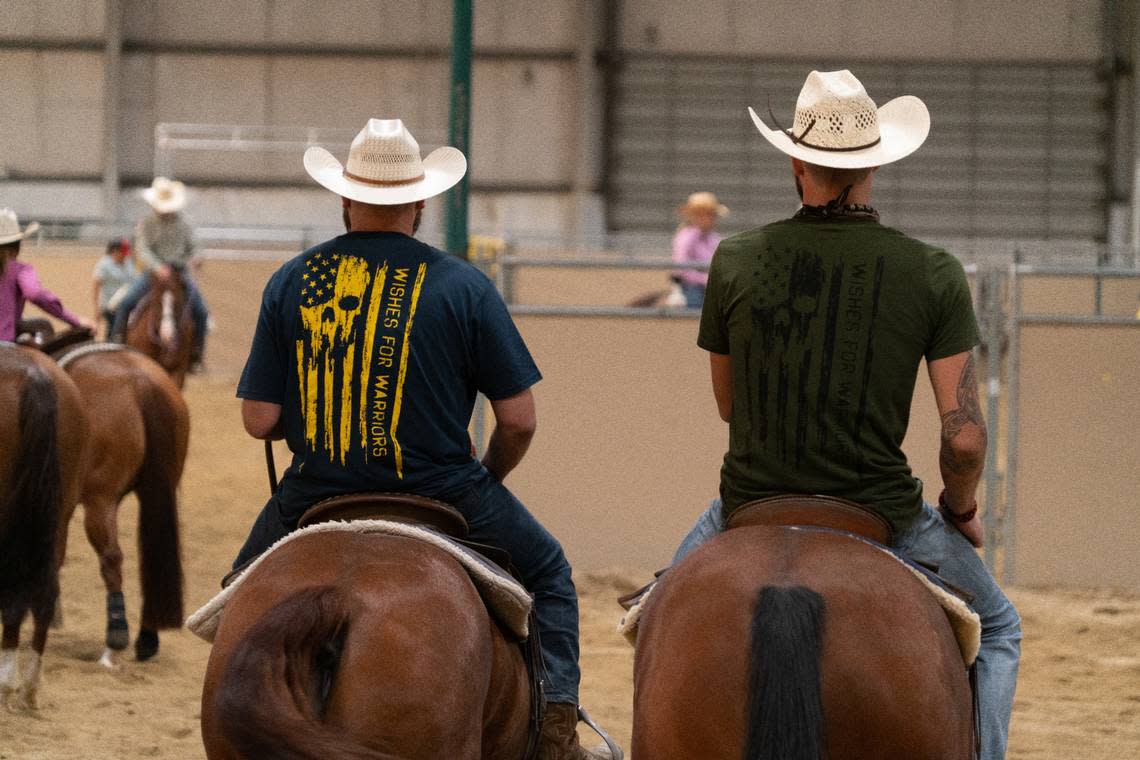 Two participants in the Wishes 4 Warriors program participate in a cutting horse event at the Ford Idaho Center in October 2021. Wishes 4 Warriors is a veteran-run nonprofit organization that provides recreational therapy and outdoor adventures for combat-wounded veterans.